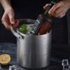 Large capacity stainless steel double-walled ice bucket with lid for champagne, beer, and wine.