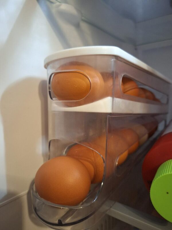 Double-layer rolling egg dispenser, automatic space-saving storage for fridge and cabinets, keeps eggs fresh, ideal for kitchen organization.