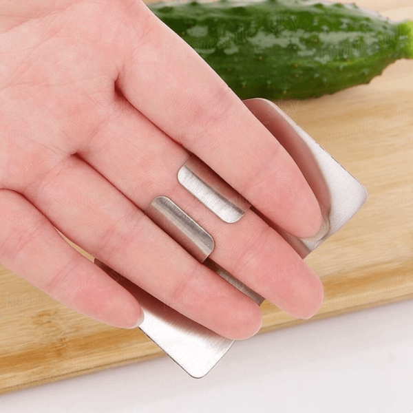 Stainless steel finger guard designed to protect fingers while slicing, with a curved, adjustable fit.