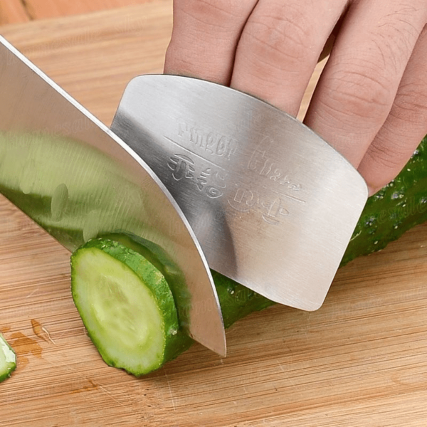 Stainless steel finger guard designed to protect fingers while slicing, with a curved, adjustable fit.