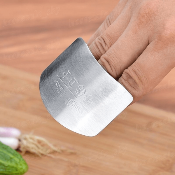 Stainless steel finger guard designed to protect fingers while slicing, with a curved, adjustable fit.