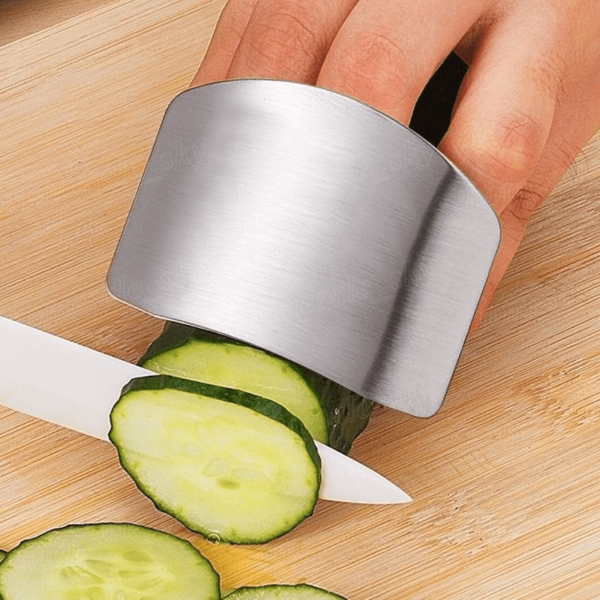 Stainless steel finger guard designed to protect fingers while slicing, with a curved, adjustable fit.