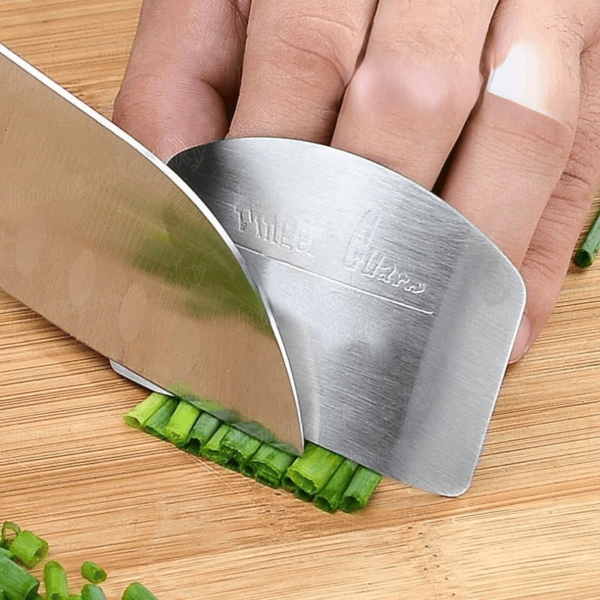 Stainless steel finger guard designed to protect fingers while slicing, with a curved, adjustable fit.