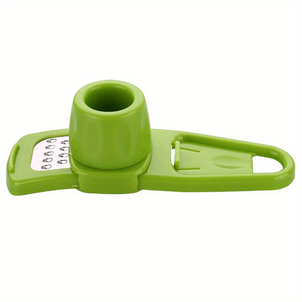 Manual garlic press and grater tool for crushing and grating garlic and ginger.