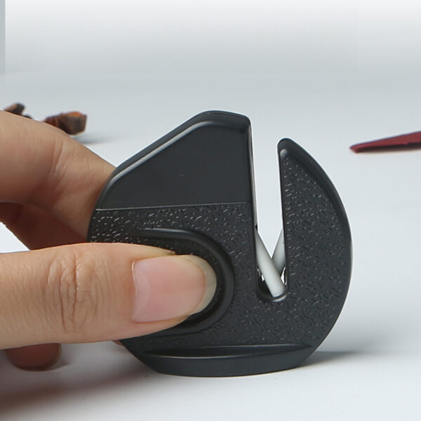 Portable mini knife sharpener for quick and easy sharpening of kitchen knives.