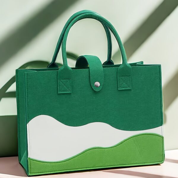 Chic colorblock felt tote bag for women with large capacity, secure closure, and wrist strap.