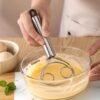 Stainless steel whisk with double-eye rings, perfect for mixing flour, beating cream, and dough mixing in baking and cooking.