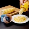 Stainless steel corn cob sheller for easy and manual removal of corn kernels.