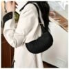 Fashion top-handle handbag for women in black, khaki, and green with solid color design, fixed shoulder straps, faux leather lining, and zipper closure.