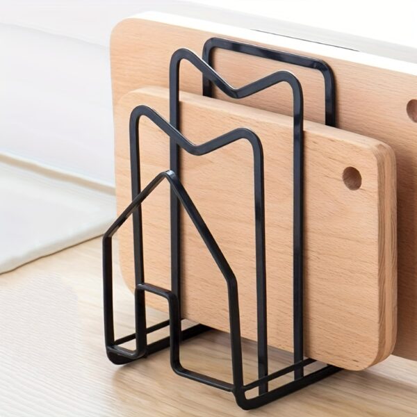 Metal pot lid and cutting board holder for organized kitchen storage.