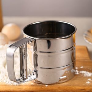 Stainless steel handheld flour sifter with double-layer fine mesh, ideal for baking and cooking.