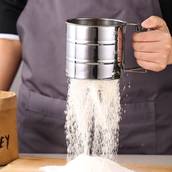 Stainless steel handheld flour sifter with double-layer fine mesh, ideal for baking and cooking.