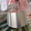 Stainless steel finger guard designed to protect fingers while slicing, with a curved, adjustable fit.