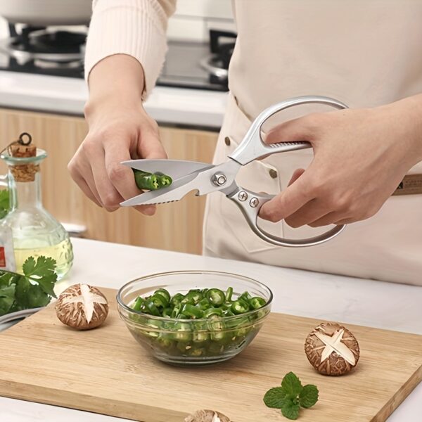 Ergonomic stainless steel kitchen scissors with comfortable handles, designed for cutting through various kitchen tasks.