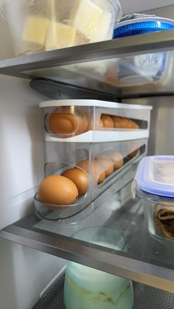 Double-layer rolling egg dispenser, automatic space-saving storage for fridge and cabinets, keeps eggs fresh, ideal for kitchen organization.