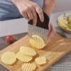 Stainless steel wave-shaped potato slicer, designed for cutting potatoes into wavy, uniform slices.