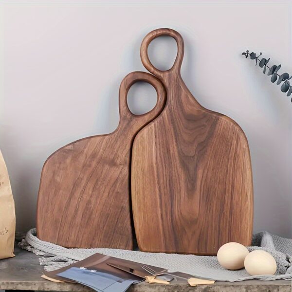 2-piece walnut chopping board set made from solid wood with form-fitting design and hanging hole