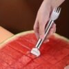 2-in-1 stainless steel watermelon slicer and fork, designed for easy and efficient cutting and serving of watermelon.