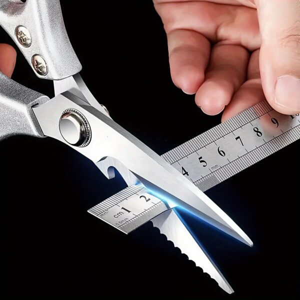 Ergonomic stainless steel kitchen scissors with comfortable handles, designed for cutting through various kitchen tasks.