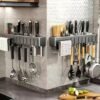 Wall-mounted carbon steel kitchen utensil holder for organizing cooking tools and utensils.