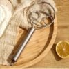Stainless steel whisk with double-eye rings, perfect for mixing flour, beating cream, and dough mixing in baking and cooking.