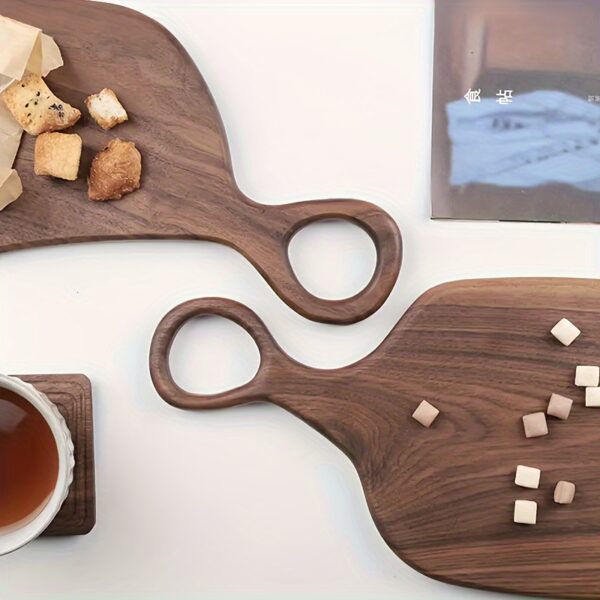 2-piece walnut chopping board set made from solid wood with form-fitting design and hanging hole