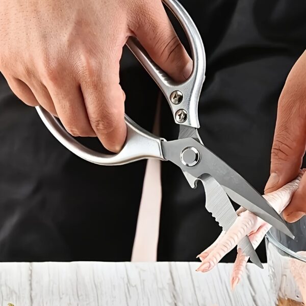 Ergonomic stainless steel kitchen scissors with comfortable handles, designed for cutting through various kitchen tasks.