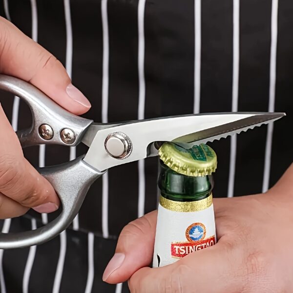 Ergonomic stainless steel kitchen scissors with comfortable handles, designed for cutting through various kitchen tasks.