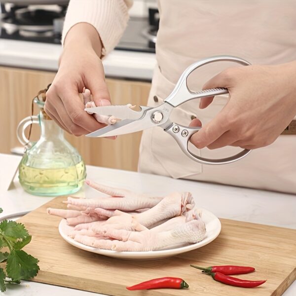 Ergonomic stainless steel kitchen scissors with comfortable handles, designed for cutting through various kitchen tasks.