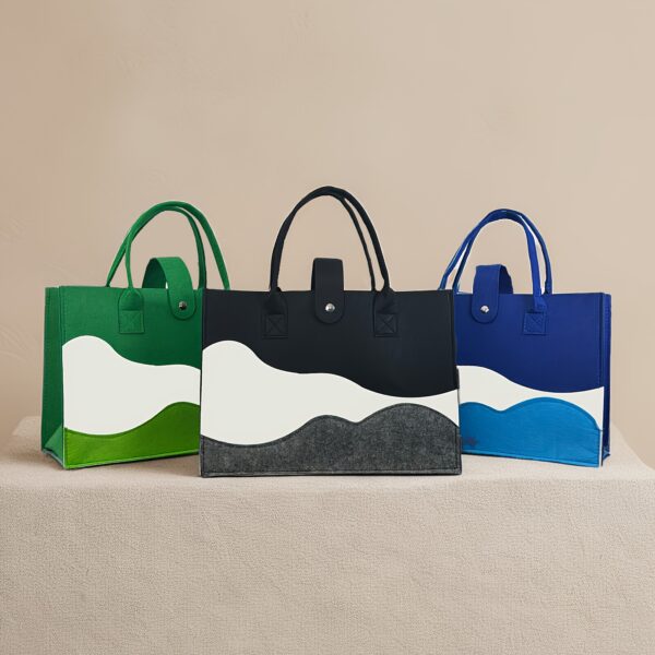 Chic colorblock felt tote bag for women with large capacity, secure closure, and wrist strap.