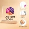Customizable acrylic logo plaque with a wooden stand.