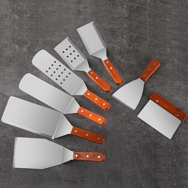 Premium stainless steel spatula set with wooden handles for cooking and flipping.