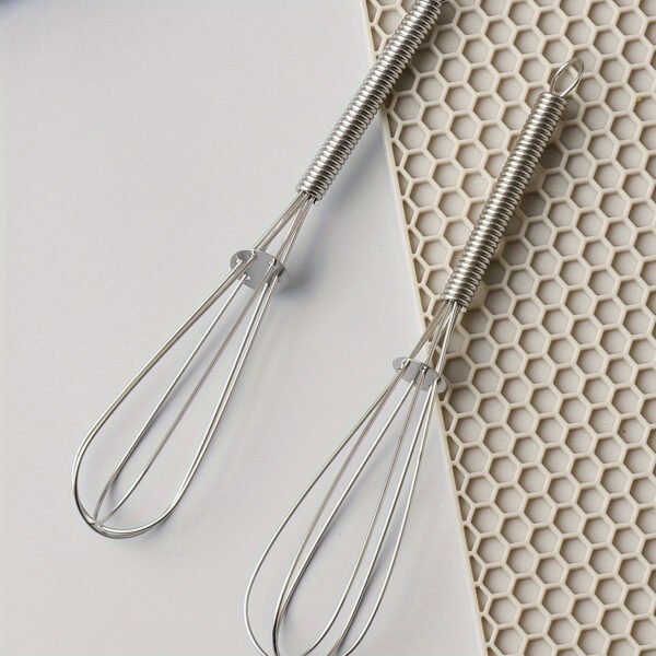 Stainless steel whisk for mixing, whipping, and beating eggs and batter.