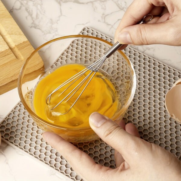 Stainless steel whisk for mixing, whipping, and beating eggs and batter.