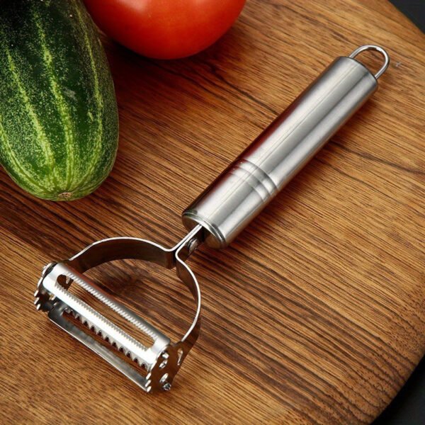 Stainless steel 2-in-1 peeler and shredder tool for peeling and shredding fruits, vegetables, and more.