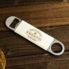 Custom metal beverage opener with personalized name engraving.