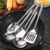Stainless steel kitchen utensil set including spatula, ladle, turner, colander, and more.