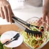 Heat-resistant multi-purpose kitchen tongs for cooking, grilling, and serving.
